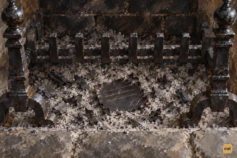 One burnt slip of a woman's letter survives in the cold grate of Sir Charles's study